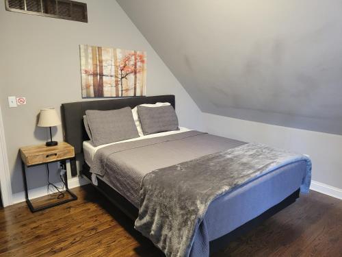 a bed with two pillows on it in a bedroom at Modern Rustic split level with balcony in Cincinnati