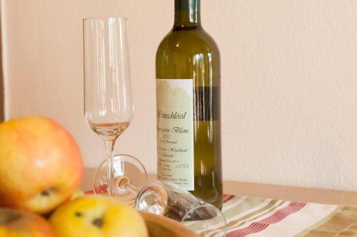 a bottle of wine sitting next to a glass at Appartement Philips in Flachau