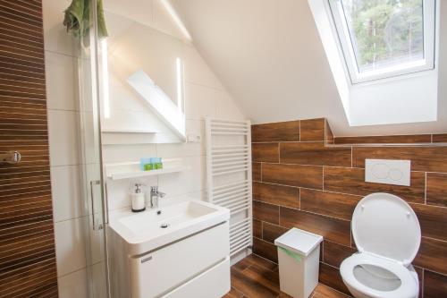a bathroom with a toilet and a sink and a window at Podskalí Adršpach in Teplice nad Metují