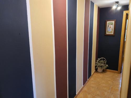 a hallway with stripes on the wall at HOTEL MASIA EL MOLINETE in Mora de Rubielos