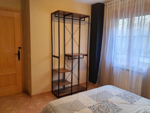 a bedroom with a book shelf next to a bed at HOTEL MASIA EL MOLINETE in Mora de Rubielos