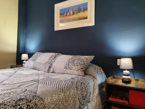a bedroom with a bed and a painting on the wall at HOTEL MASIA EL MOLINETE in Mora de Rubielos