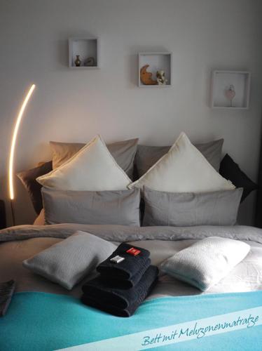 a bed with pillows on top of it at Fewo Nationalpark Schwarzwald in Freudenstadt
