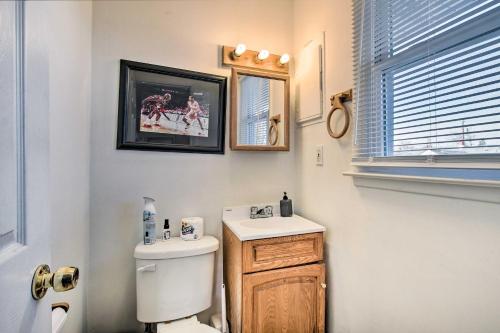 a bathroom with a toilet and a sink and a window at House with Pellet Smoker and Grill, 1 Mi to Lake! in Bellmawr