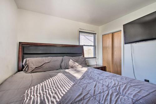 a bedroom with a bed and a refrigerator at House with Pellet Smoker and Grill, 1 Mi to Lake! in Bellmawr