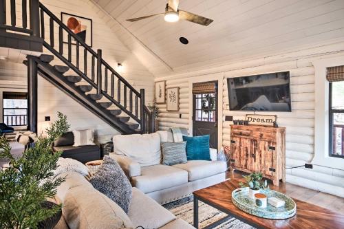 a living room with a couch and a table at Enchanting Forested Cabin with Fire Pit and Grill in Sulphur Springs