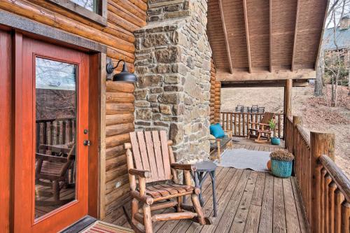 a porch with two rocking chairs on a wooden deck at Enchanting Forested Cabin with Fire Pit and Grill in Sulphur Springs