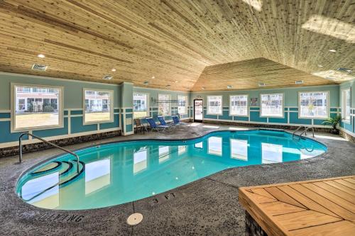 a large swimming pool in a building with a wooden ceiling at Emerald Isle Condo with Indoor Pool and Beach Access! in Emerald Isle