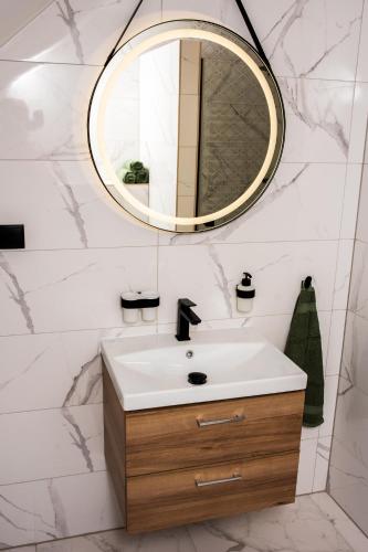 a bathroom with a sink and a mirror at Agroturystyka Bocian Biały in Kiwity