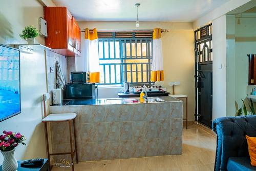 a kitchen with a counter top in a room at STYLISH 1BR APARTMENT IN KISUMU: FAST WI-FI, NETFLIX, SECURE PARKING in Kisumu