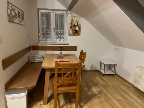 a dining room with a wooden table and chairs at Ferienwohnungen Fam. Pabst in Maria Lankowitz