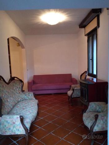 a living room with a red couch and two chairs at Apartment venezia in Mestre