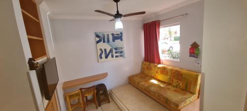 a living room with a couch and a window at diRoma Fiori - Apartamentos JN in Caldas Novas