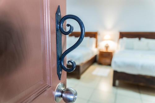 an open door to a bedroom with two beds at Casa Graciela Hotel Pátzcuaro in Pátzcuaro