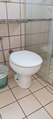 a white toilet in a bathroom with a shower at diRoma Fiori - Apartamentos JN in Caldas Novas