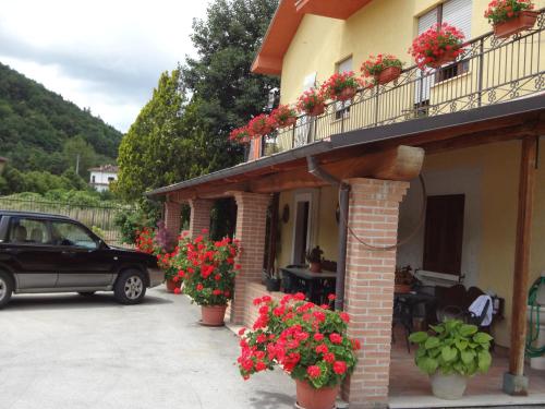 a car parked in front of a building with flowers at Le Stanze di Bacco in Cagnano Amiterno