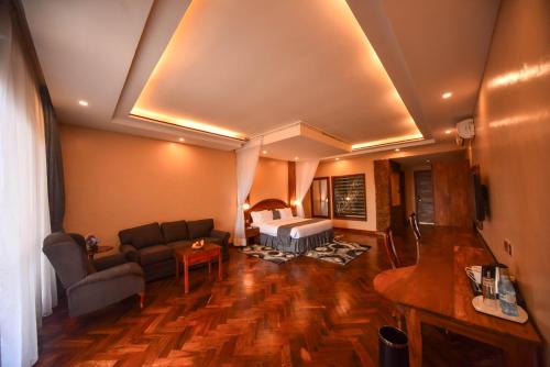 een woonkamer met een bank en een tafel bij Kalanoga Resort in Kampala