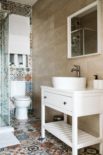 a bathroom with a sink and a toilet at Ta' Tereza Apartment in Gozo in Qala