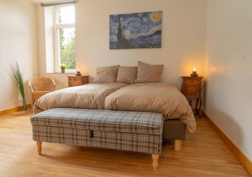 a bedroom with a bed with a ottoman in it at Open Source à l'entrée du Circuit! in Stavelot
