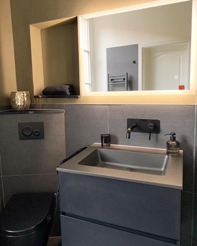 a bathroom with a sink and a mirror at Redlinburg I in Quedlinburg