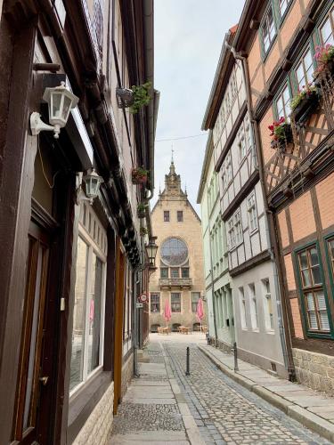 an alley with buildings and a church in the background at Redlinburg I in Quedlinburg