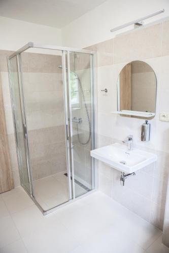 a bathroom with a shower and a sink at Lidový dům Halenkov in Halenkov