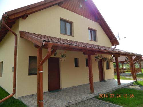 a house with awning on the side of it at Casa Loksi in Sovata