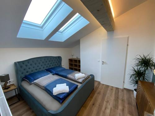 a bedroom with a bed with a skylight at Living8-Appartements in Bad Ischl