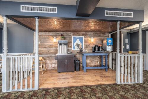 a room with a wooden wall with a counter and a table at The Dakota in Sioux Falls
