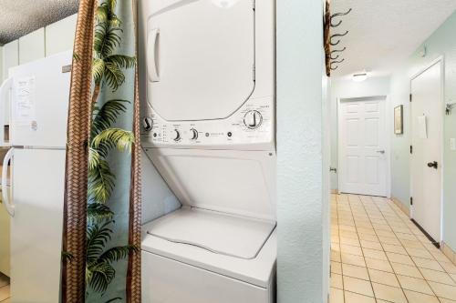 a laundry room with a washer and dryer at Sea Village #3-203 in Kailua-Kona