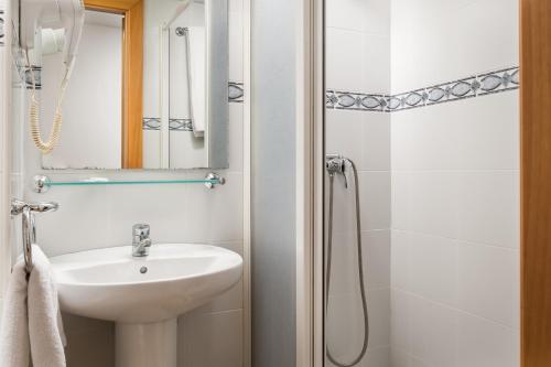 a bathroom with a sink and a shower at Hostal Baler in Barcelona