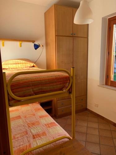 a bedroom with two bunk beds and a cabinet at La Finestra su Mothia in Marsala