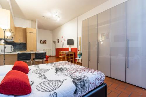 a bedroom with a bed with red pillows on it at Firenze Rentals Suite Oche in Florence