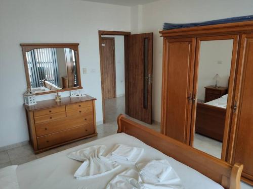a bedroom with a bed and a dresser and a mirror at Sun Coast Apartment in Sveti Vlas