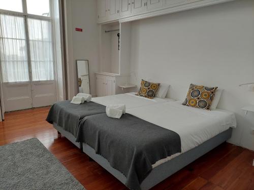 Ένα ή περισσότερα κρεβάτια σε δωμάτιο στο CC Guest House - "Ao Mercado"