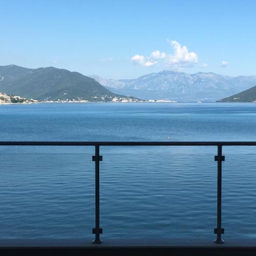 a view of a large body of water with mountains at Hotel Vienna in Herceg-Novi