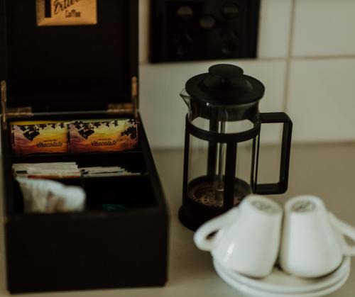 a blender sitting on a counter next to a plate at Quest Napier Serviced Apartments in Napier
