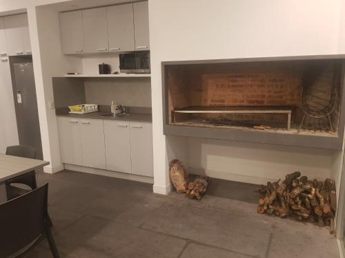 a kitchen with a large oven in the wall at Ocean Drive Country - Punta del Este in Punta del Este