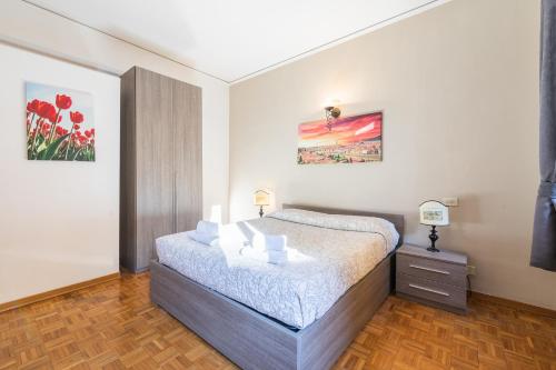 a bedroom with a bed and a painting on the wall at Firenze Rentals Ponte Vecchio Flat in Florence