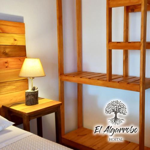 a bedroom with a tree on the wall at Hostal El Algarrobo in Casa Grande