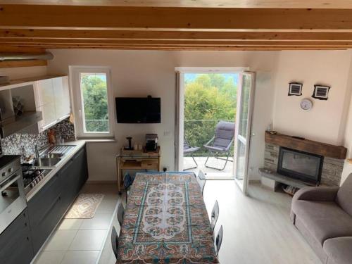 a kitchen and living room with a couch and a table at Casa Vista Monte Rosa in Toceno