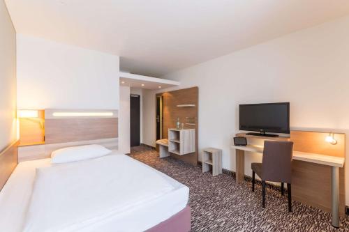 Télévision ou salle de divertissement dans l'établissement Park Inn by Radisson Göttingen