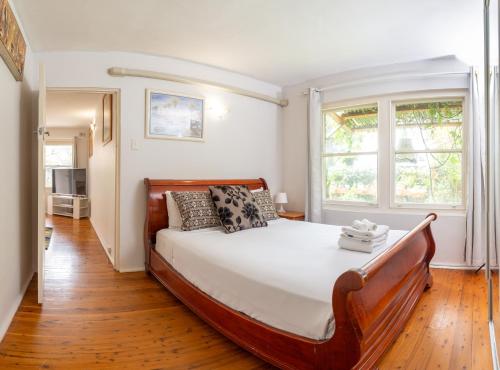 a bedroom with a large bed and a window at Lotus Stay Manly - Apartment 31A in Sydney