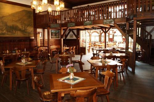 a dining room with wooden tables and chairs at Braugasthof Papiermühle in Jena