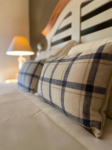 a bed with two pillows on it with a lamp at NEW Contemporary Chalet 5 Bed/3 Bath in Split Rock in Lake Harmony