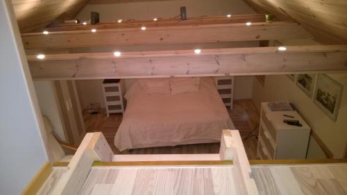 a loft bed in a tiny house with lights at Comfortable Bungalow in Ísafjörður