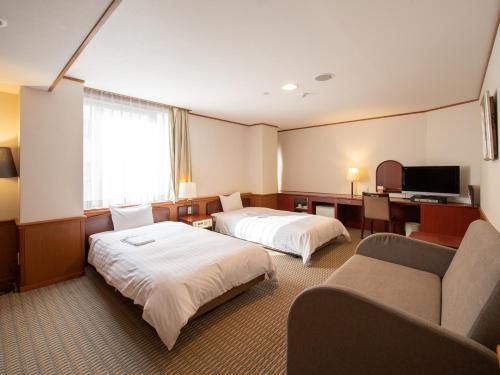 Postel nebo postele na pokoji v ubytování Hotel Iidaya