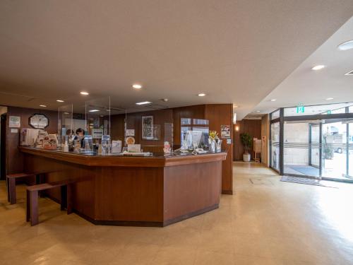a lobby with a large counter in a building at Hotel Iidaya in Matsumoto