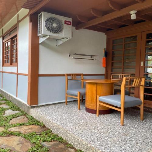 a patio with a table and chairs and a fan at SF Homey Yokohama in Cikundul