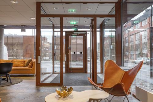 a lobby with chairs and a table and a couch at Boo Boo Living in Stockholm